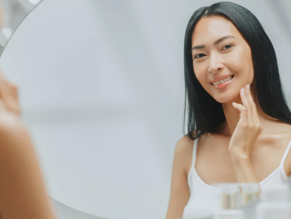 Asian woman touching chin - Kybella